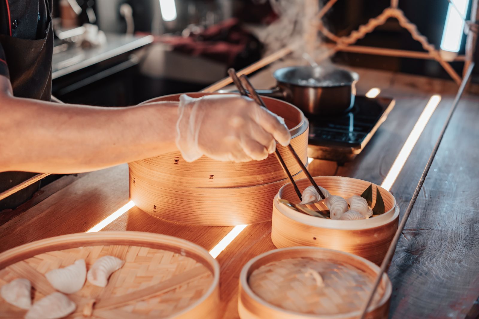Dumplings going into a bamboo steamer